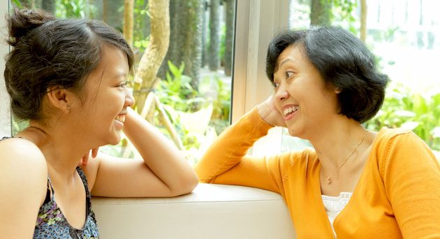 Woman and her mother sitting and smiling